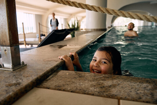 father and daughter in indoor swimming pool