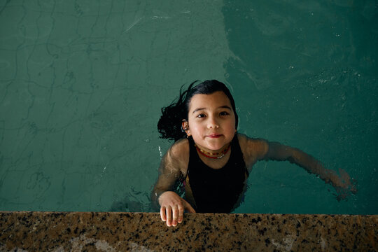girl swimming in indoor swimming pool at hotel
