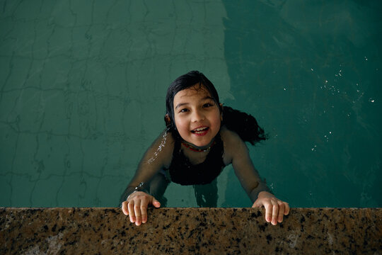 girl swimming in indoor swimming pool at hotel