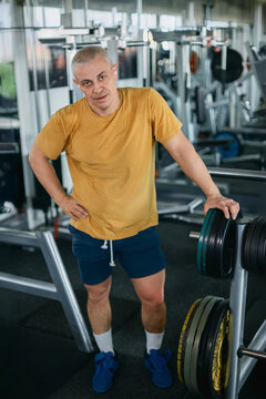 Muscular man resting after a workout in the gym