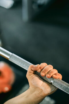 Close-Up of a Hand Gripping a Barbell in a Gym