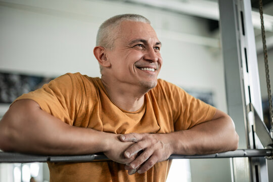 Smiling man resting after a workout in the gym - Powered by Adobe