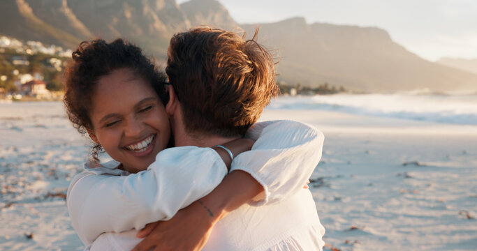 Hug, smile and couple at beach for love, care and interracial relationship together. Seashore, happy man and woman embrace outdoor for summer holiday, travel or romantic date with partner for support - Powered by Adobe
