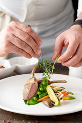 lamb chops with various vegetables at a fine dining restaurant