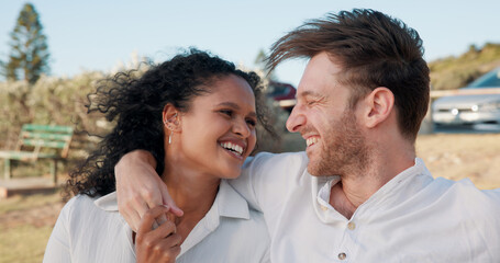 Fototapeta premium Happy, interracial couple and laughing together outdoor for funny joke, relationship support and romantic weekend. Date, people and relax in nature for travel holiday, trust or commitment in marriage