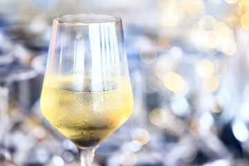 a glass of white wine served in a restaurant, abstract background of a summer restaurant