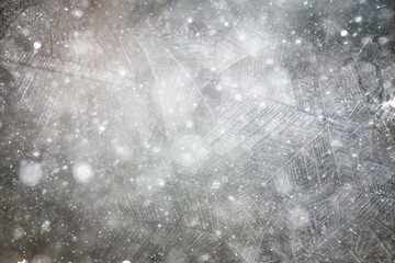 white winter background, frosty patterns on glass, abstract backdrop of ice and snow crystals in a blur