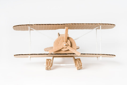 Handmade cardboard biplane front view, DIY vintage airplane model