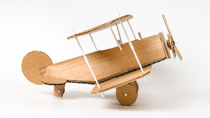 Handmade cardboard biplane side view, DIY vintage airplane model © Iana Alter
