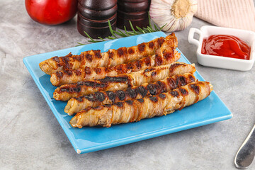 Grilled meat sausages wrapped bacon