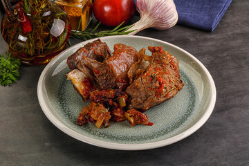 Baked beef ribs with vegetables