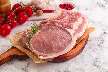 Raw potk loin steak with bone
