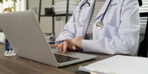 Virtual Healthcare and Patient Consultation. A medical professional navigating through online...