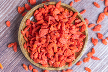 Healthy Dried Goji Berries in a Bowl on Rustic Wooden Surface