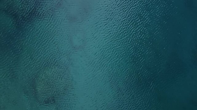 This aerial view captures a tranquil water surface, perfect for relaxation and meditation