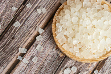Top View of a Plate of Rock Sugar on Wooden Background