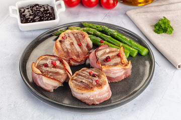 Tasty grilled pork medallion with bacon