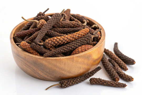 Dried Indian Long Pepper (Piper Longum) in Wooden Bowl on White Background