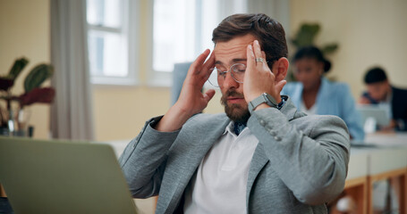 Laptop, businessman and headache in office for stress, brain fog and fatigue for auditing deadline....