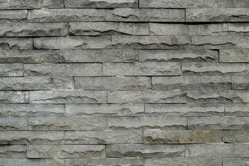 Wall covered with neatly arranged square stones. Pattern and texture of stone walls. For graphic design, 3D rendering and banner background
