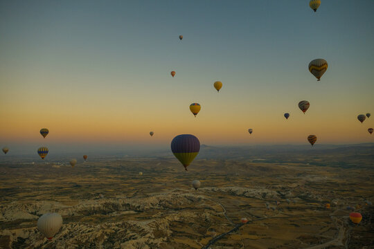 Beautiful sunrise with clear skies full of balloons in Cappadocia