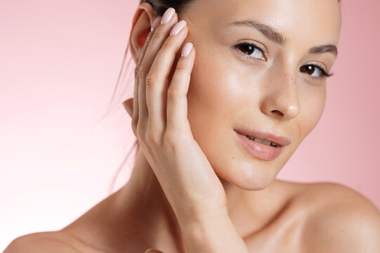 Pretty woman with natural beauty posing over pink background