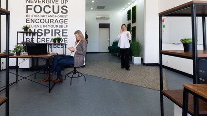 Modern coworking space featuring professionals engaged in collaborative activities and motivational wall decor