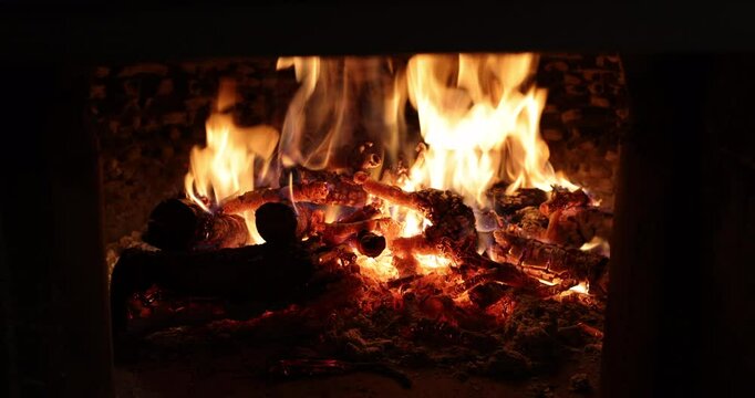Glowing Firewood and Bright Flames in Rustic Brick Oven