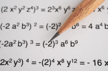 Pencil on mathematic formula exercise test paper in education school.