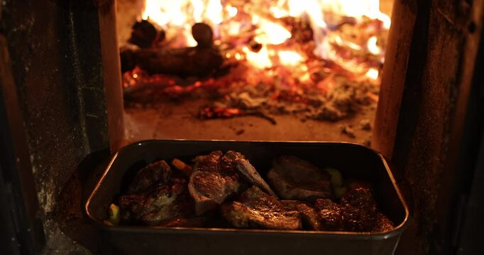 Roasted Meat Cooking in Rustic Wood-Fired Oven with Open Flames
