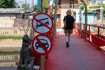 No cars allowed traffic sign on a community road. Red round sign with a vehicle crossed out, indicating that cars are prohibited