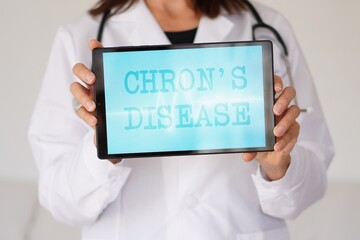 chron's disease. medical concepts. woman doctor with a tablet with written words.