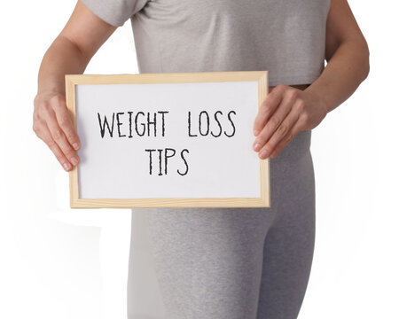 weight loss tips concept. words written on a white board with a woman dressed in sports clothes.