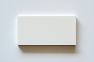 A rectangular object is casting a shadow on a white surface