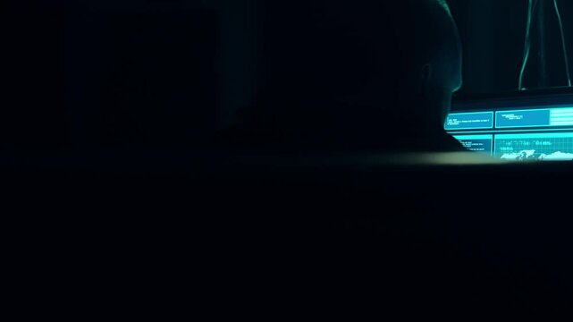 Wanted hackers coding virus ransomware using laptops and computers in the basement. Cyber attack, system breaking and malware concept.