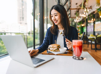 Adult business asian woman thinking for idea writing daily journal at indoors cafe