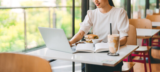 Fototapeta premium Adult business asian woman thinking for idea writing daily journal at indoors cafe