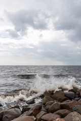 Waves splashing on stone shore.