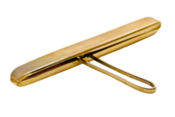 A golden squeegee resting elegantly on a bright surface, showcasing intricate details and a simple yet artistic design