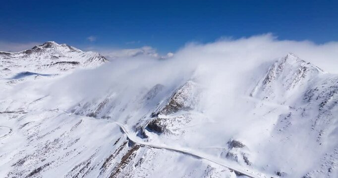 Beautiful aerial view of snow-capped mountains in Sichuan China, with mist floating on the ridges. Jiajin Mountain