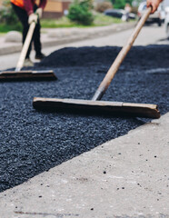 Roadworks, process of asphalting, blacktopping and paving new road layer, laying new asphalt road...