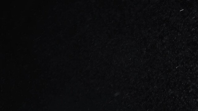 small drops of rain, snow on a black background. wind. Natural background