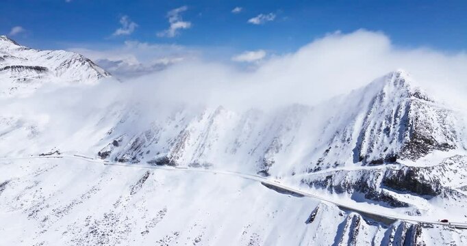 Beautiful aerial view of snow-capped mountains in Sichuan China, with mist floating on the ridges. Jiajin Mountain