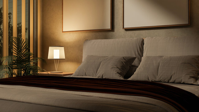 The set of grey pillows and blanket on a large bed in the empty bedroom under warm lamp light.