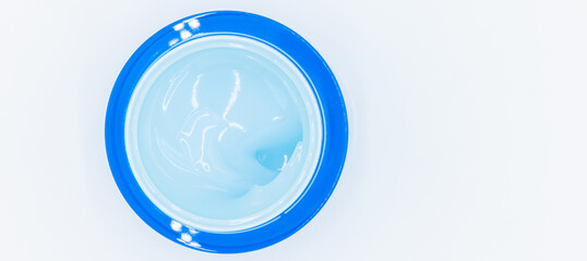 Top view blue water gel cosmetic serum in blue container, Liquid gel moisturizer, Blue gel serum texture make up and cosmetic texture background, skincare product and beauty cream..