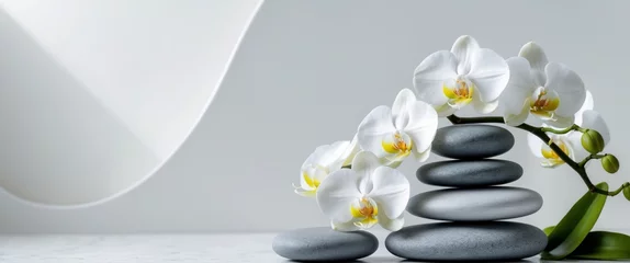 Keuken achterwand Spa A serene spa scene featuring a stack of smooth grey stones with white orchids balanced on top  © Ta Sher