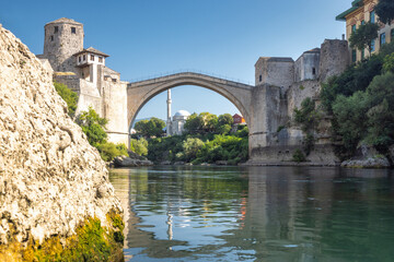 The Stari Most bridge, old bridge on Neretva river in Mostar town, Bosnia and Herzegovina, Europe. Iconic stone arch bridge spans a river with historic towers flanking its sides. © Viliam