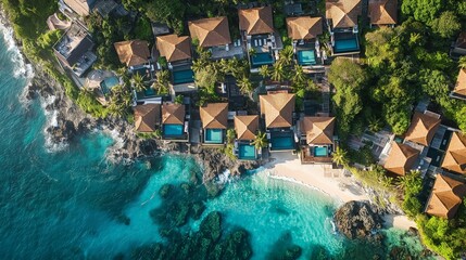 Fototapeta premium aerial view of luxurious tropical beach island resort with pool villa at sea shore, drone view 