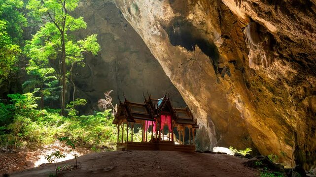 Time lapse of tourists admiring a stunning buddhist shrine nestled within the renowned phraya nakhon cave in Thailand