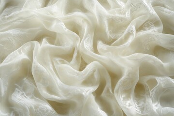 Fototapeta premium Cream-colored fabric with delicate embroidered pattern, softly draped and textured.